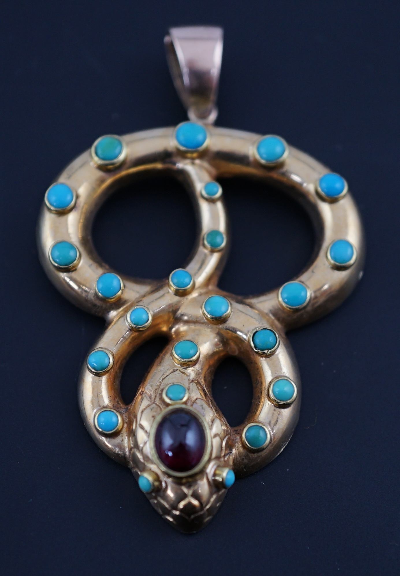 A Victorian gold, turquoise and cabochon garnet set entwined serpent pendant